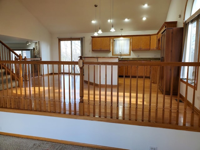 kitchen with vaulted ceiling, pendant lighting, and kitchen peninsula