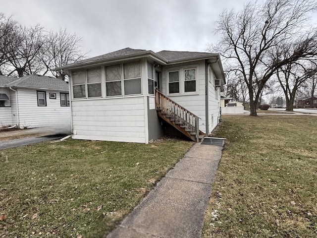 bungalow-style home with a sunroom and a front lawn