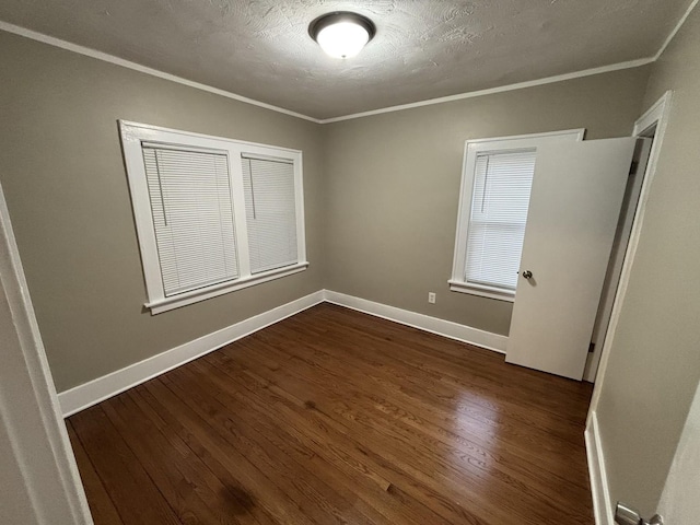 unfurnished bedroom featuring dark hardwood / wood-style flooring, ornamental molding, and a textured ceiling