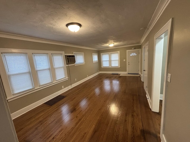 entryway with a wall mounted AC, crown molding, dark hardwood / wood-style floors, and a textured ceiling