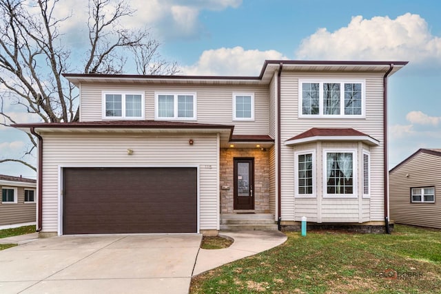 view of front of property with a garage and a front lawn