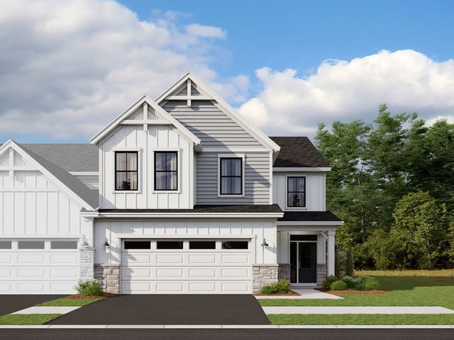 view of front of home with a front yard and a garage