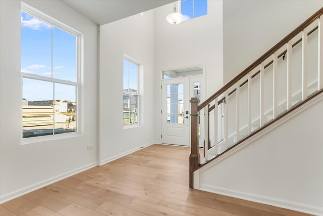 entrance foyer with plenty of natural light and light hardwood / wood-style floors