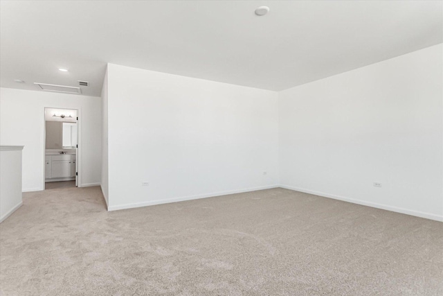 unfurnished room featuring light carpet