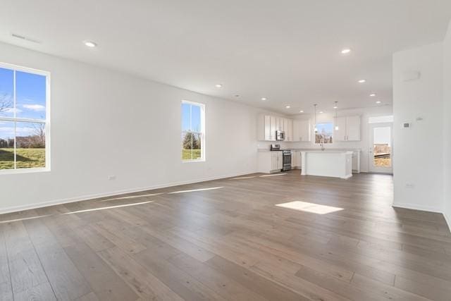 unfurnished living room with wood-type flooring