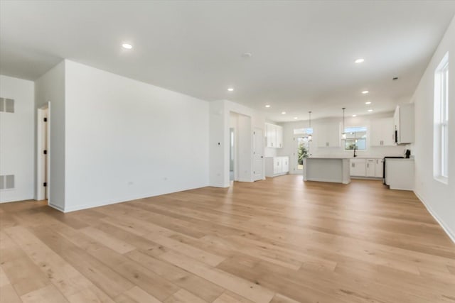 unfurnished living room with light hardwood / wood-style flooring