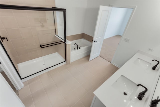 bathroom with tile patterned floors, vanity, and plus walk in shower