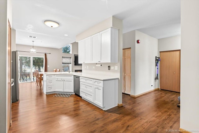 kitchen featuring white cabinetry, dishwasher, sink, dark hardwood / wood-style floors, and kitchen peninsula