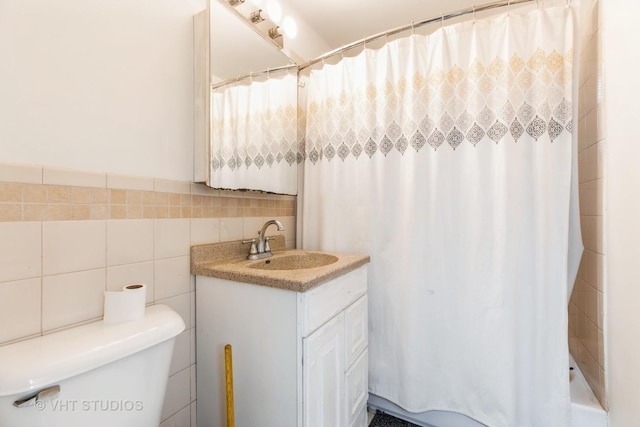 bathroom with a shower with shower curtain, vanity, toilet, and tile walls