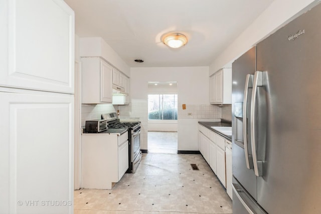 kitchen featuring tasteful backsplash, sink, white cabinets, and appliances with stainless steel finishes