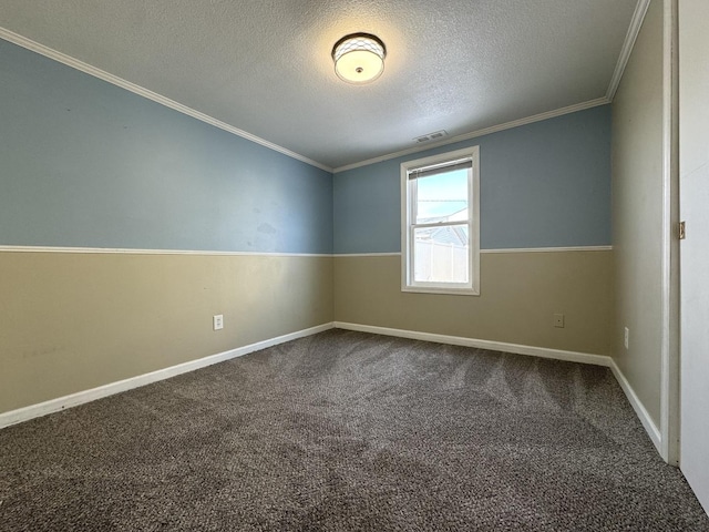 carpeted empty room with ornamental molding and a textured ceiling