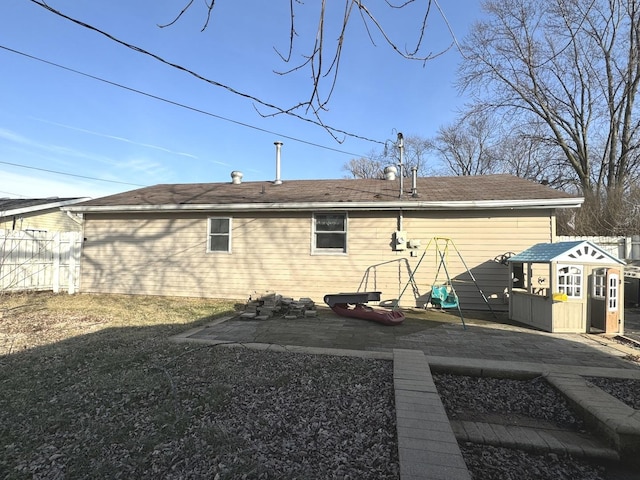 back of house featuring an outdoor structure and a patio