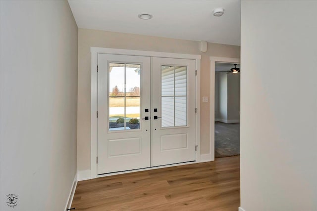 entryway with ceiling fan, light wood-type flooring, and french doors