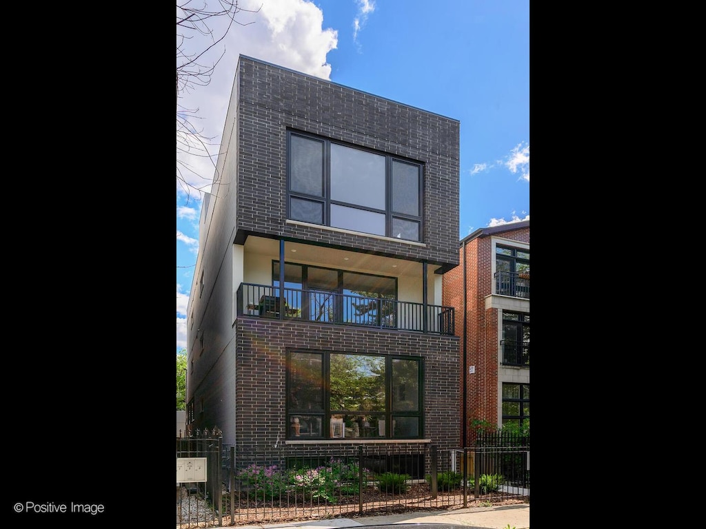 rear view of property featuring a balcony