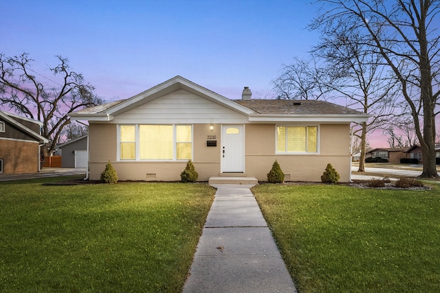 bungalow-style house with a lawn