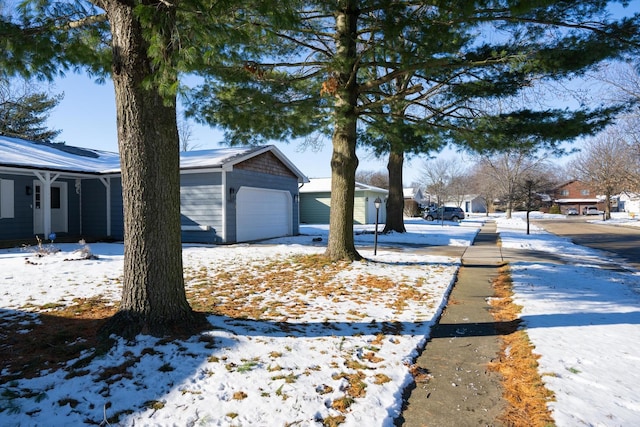 exterior space featuring a garage and an outbuilding