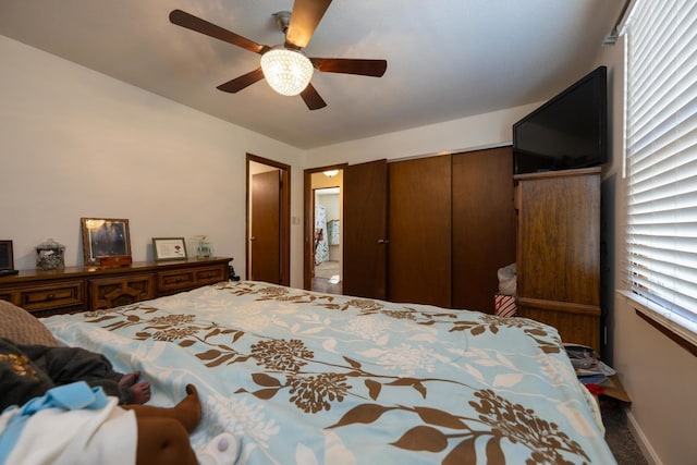 carpeted bedroom featuring a closet and ceiling fan