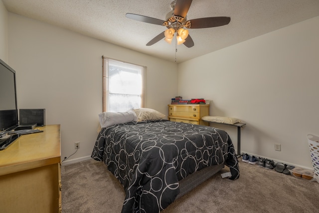 bedroom featuring ceiling fan, carpet, and a textured ceiling