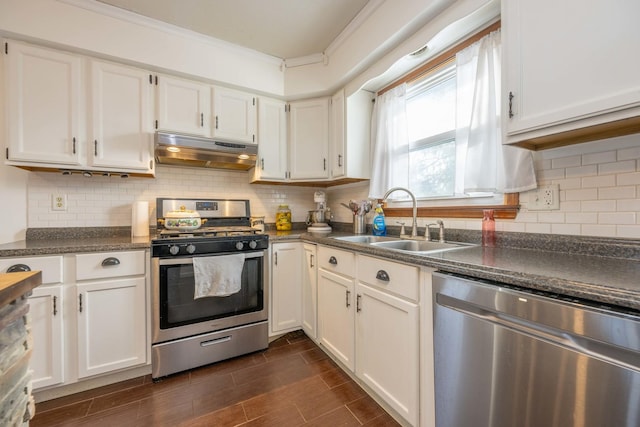 kitchen featuring tasteful backsplash, white cabinets, sink, ornamental molding, and stainless steel appliances