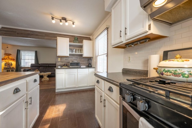 kitchen with wood counters, white cabinets, range hood, and range with gas stovetop