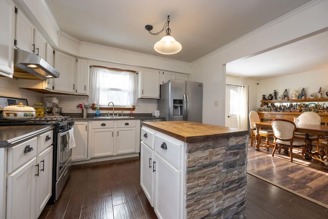 kitchen featuring white cabinets, appliances with stainless steel finishes, tasteful backsplash, sink, and hanging light fixtures