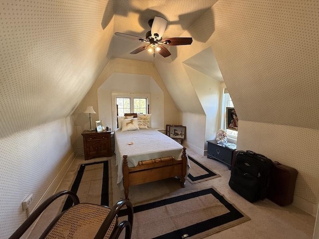 carpeted bedroom with ceiling fan and vaulted ceiling