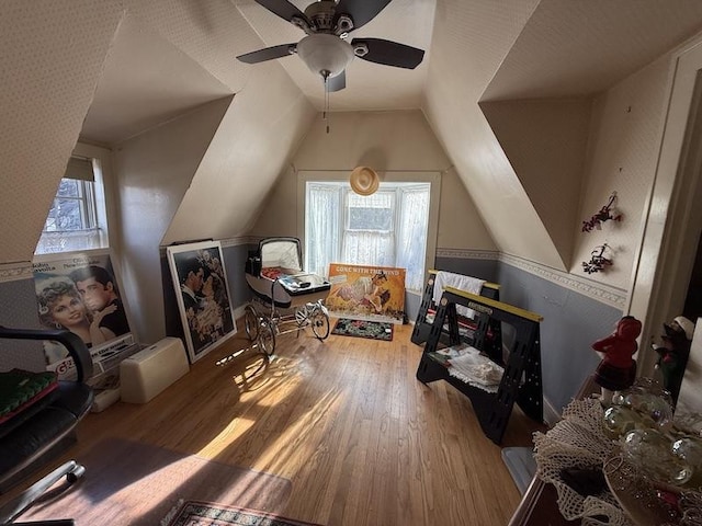 additional living space featuring ceiling fan, lofted ceiling, and hardwood / wood-style flooring