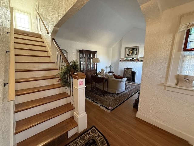 interior space with hardwood / wood-style floors and lofted ceiling