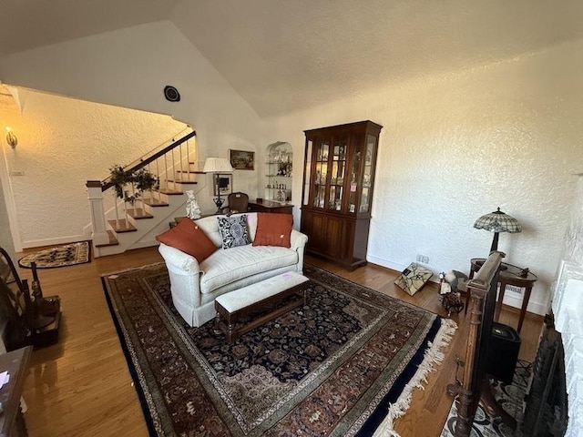 living room with high vaulted ceiling and hardwood / wood-style floors