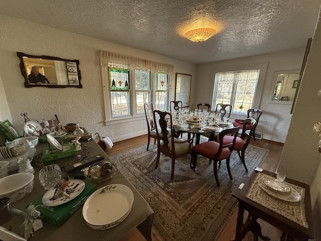 dining room with a textured ceiling and hardwood / wood-style flooring