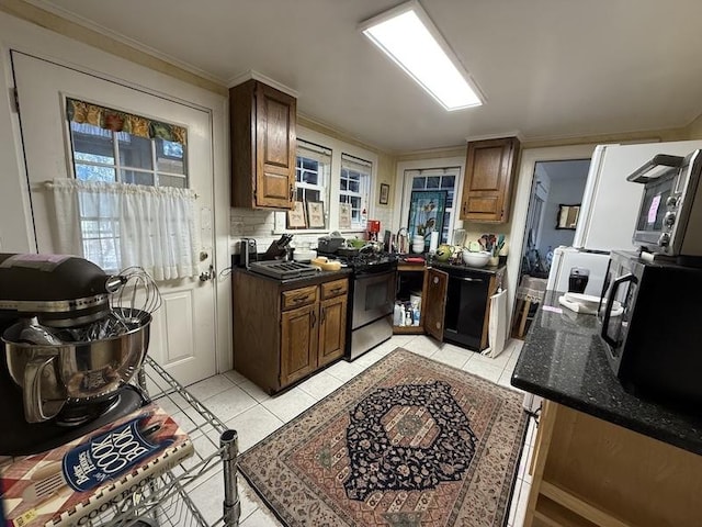 kitchen with ornamental molding, stainless steel appliances, backsplash, and light tile patterned floors