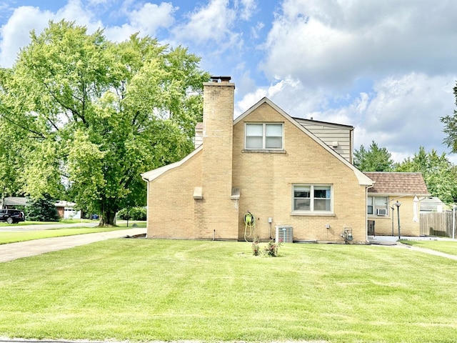 view of home's exterior with a yard and cooling unit