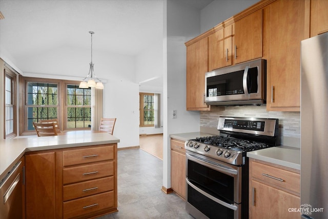 kitchen featuring a notable chandelier, decorative light fixtures, and stainless steel appliances