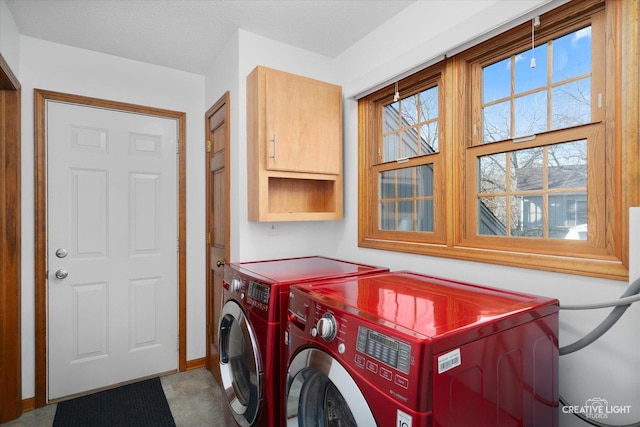 laundry area with a textured ceiling and washing machine and clothes dryer