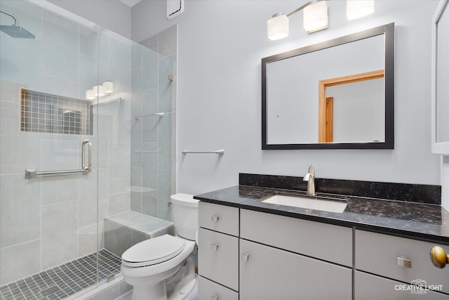 bathroom with vanity, toilet, and an enclosed shower