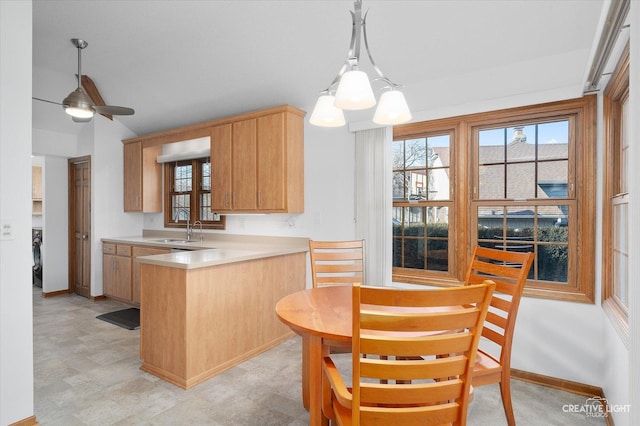 kitchen featuring ceiling fan, sink, light brown cabinetry, and kitchen peninsula