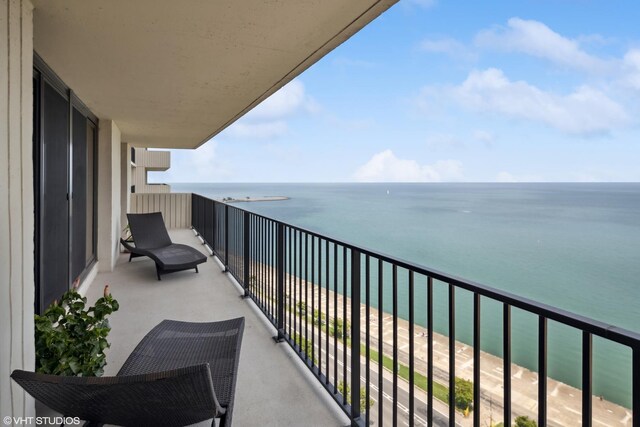 balcony featuring a water view