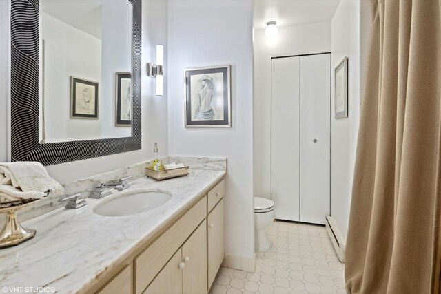 bathroom with vanity, a baseboard radiator, and toilet