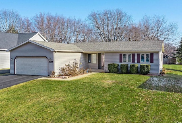 ranch-style house with a garage and a front lawn