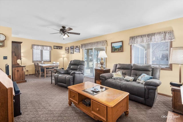 carpeted living room featuring ceiling fan