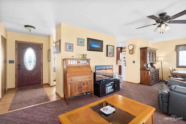 carpeted living room featuring ceiling fan and a healthy amount of sunlight