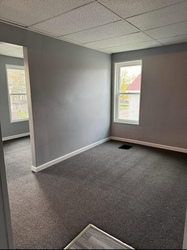 341 S Harrison Ave, Kankakee, IL 60901 - empty room with visible vents, a paneled ceiling, baseboards, and carpet