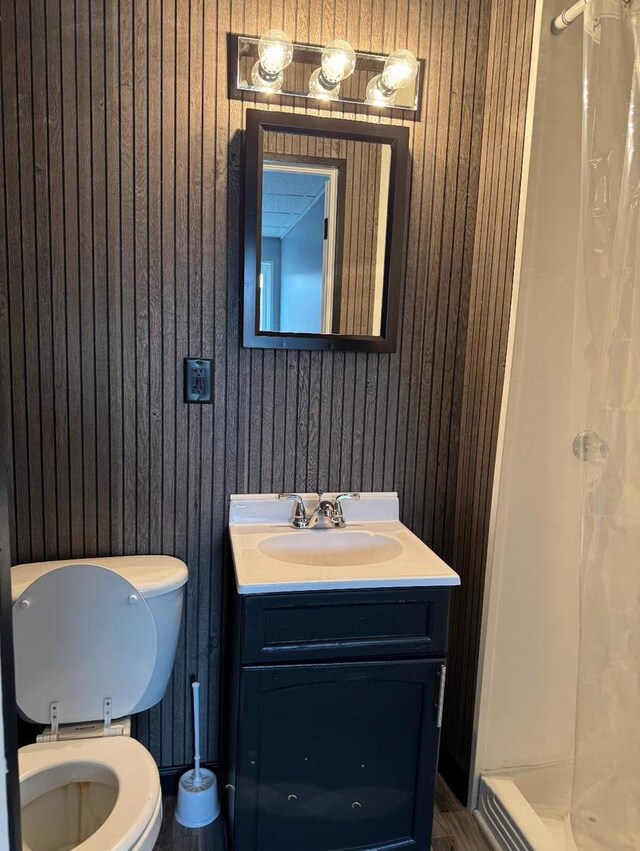 341 S Harrison Ave, Kankakee, IL 60901 - bathroom featuring wooden walls, a shower stall, and toilet