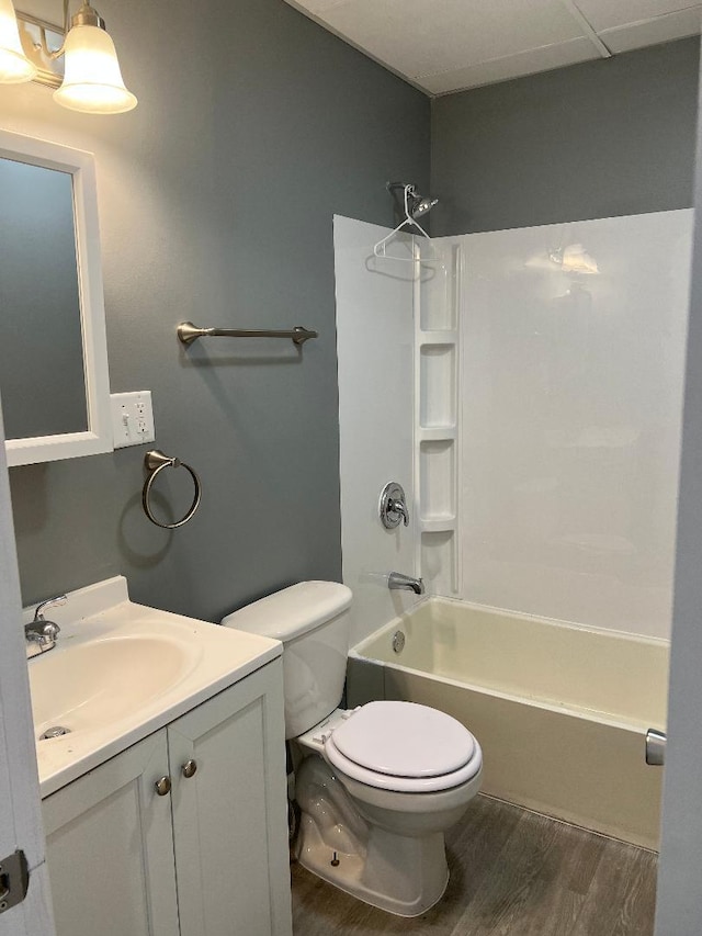 full bathroom with hardwood / wood-style floors, vanity, toilet, and shower / bath combination