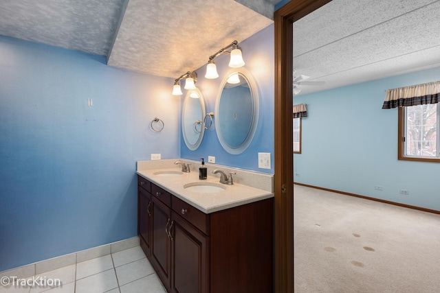 bathroom with ceiling fan, tile patterned floors, a textured ceiling, and vanity