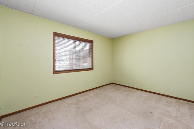 spare room with light colored carpet