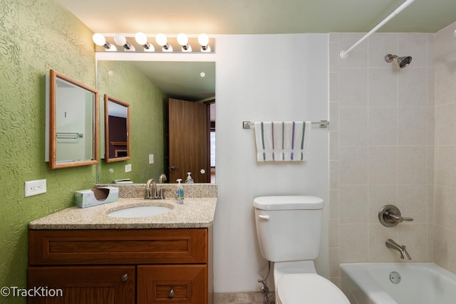 full bathroom featuring toilet, vanity, and tiled shower / bath