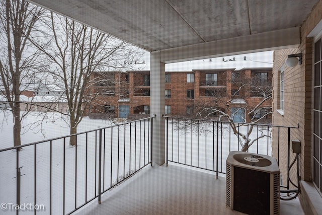 snow covered back of property with central AC unit