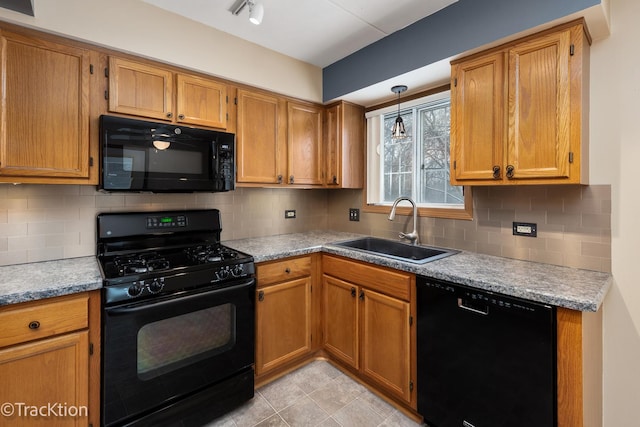 kitchen featuring hanging light fixtures, light tile patterned floors, black appliances, decorative backsplash, and sink