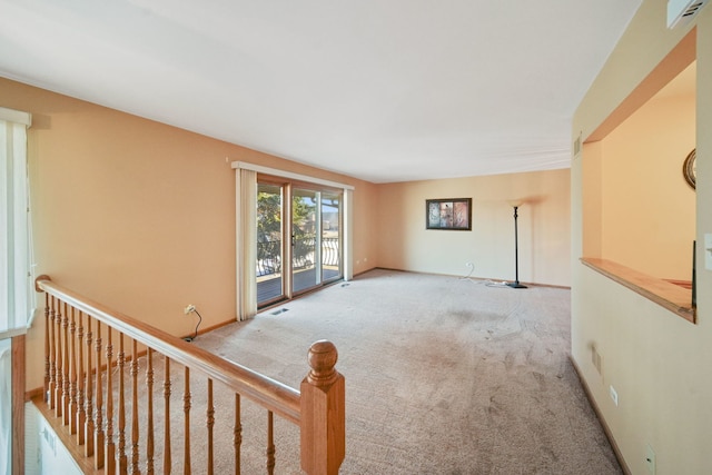 spare room featuring light colored carpet